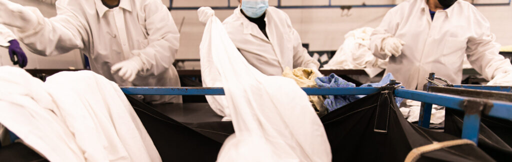 Superior Linen Service employees processing healthcare textiles